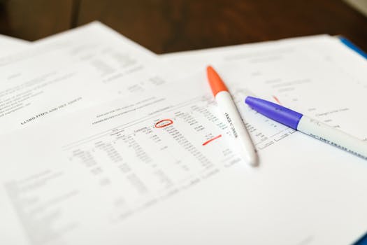 pexels-photo-7821566-7821566-1 Close-up of financial documents with pens highlighting important data points.